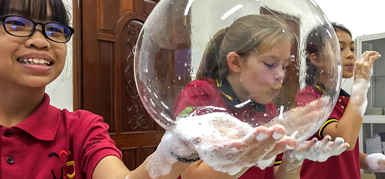 Bilingualer Chemieunterricht an der IGS: Schülerinnen am Experimentieren mit Seifenblasen